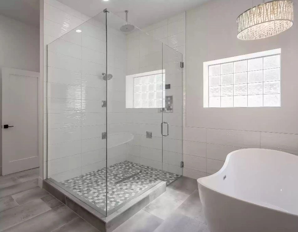 Bathroom with a glass walk-in shower, low kerb, bench seat and freestanding tub
