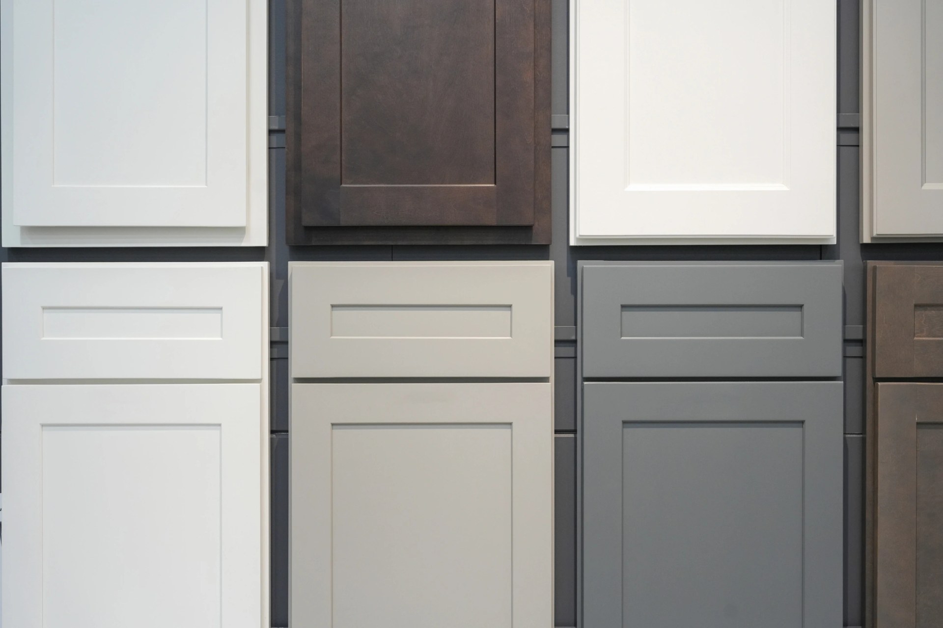 Cabinet door samples in white, grey, stone and dark stained wood